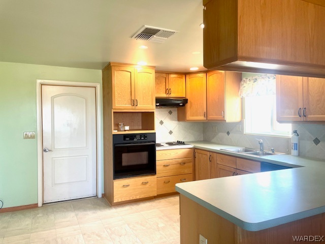 21477 South Sundance Kid Road Yucca, AZ 86438 - Photo 41 of 66 a kitchen with stainless steel appliances granite countertop a sink a stove and a refrigerator