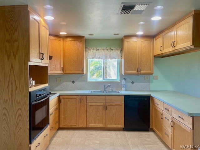 21477 South Sundance Kid Road Yucca, AZ 86438 - Photo 42 of 66 a kitchen that has a sink and a stove in it