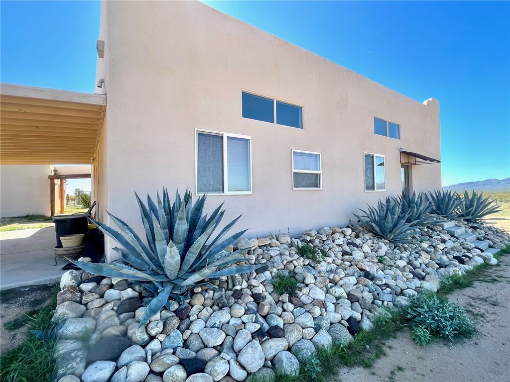 21477 South Sundance Kid Road Yucca, AZ 86438 - Photo 5 of 66 a view of a house with a small yard and potted plants