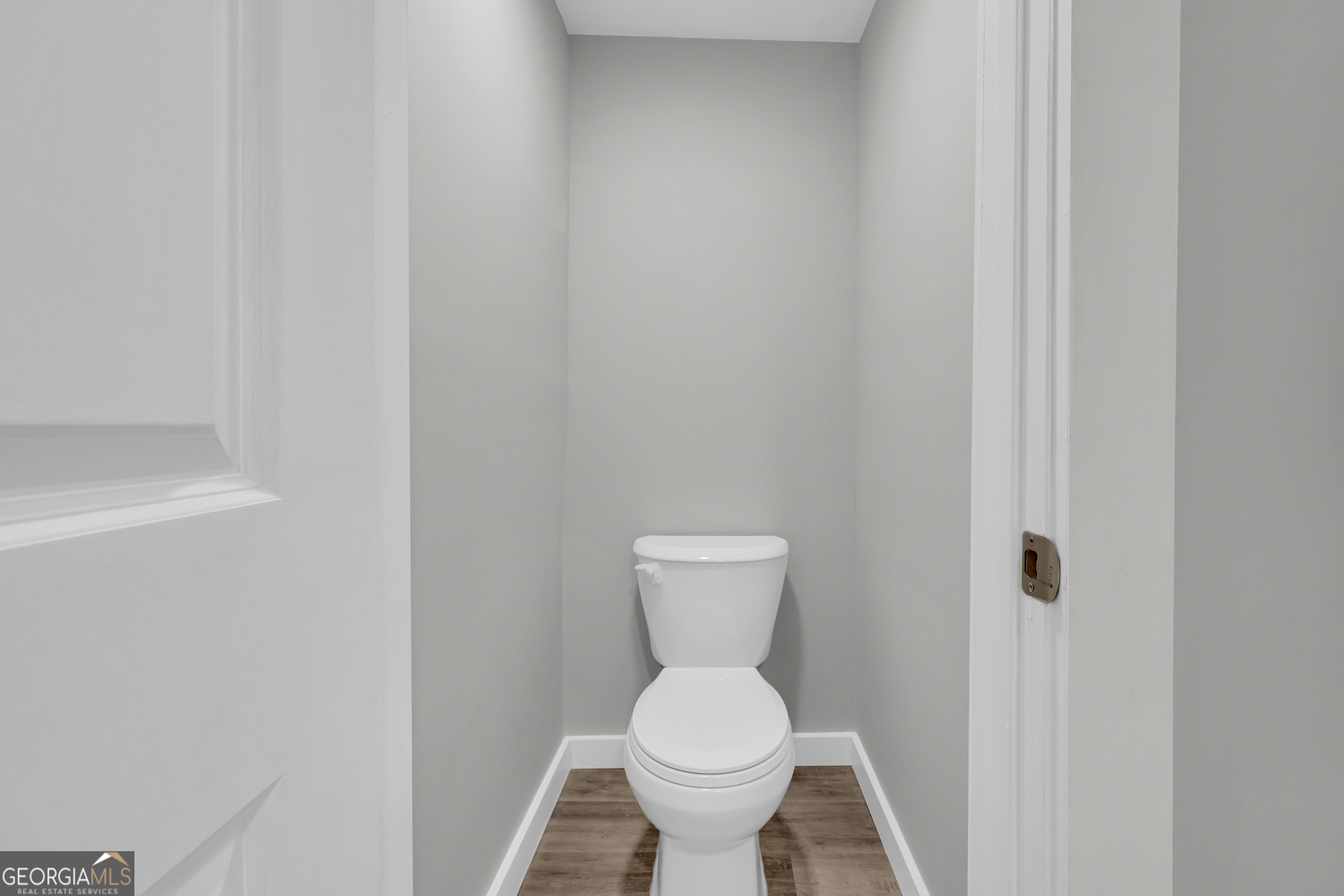 8606 Holly Springs Road Maysville, GA 30558 - Photo 47 of 74 a white toilet sitting next to a white sink