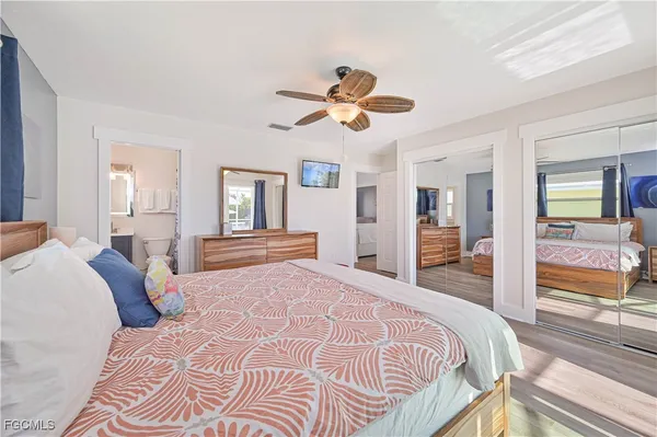 a bedroom with a large bed and a chandelier