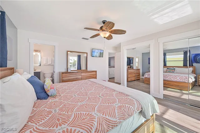 a bedroom with a large bed and a chandelier