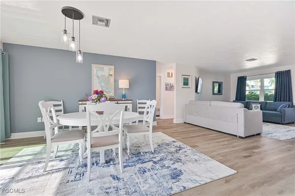 a dining room with furniture a chandelier and window