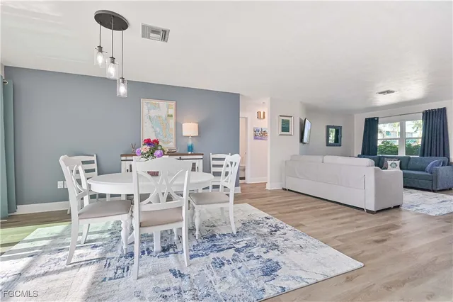 a dining room with furniture a chandelier and window