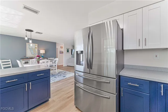 a kitchen with kitchen island wooden cabinets and stainless steel appliances