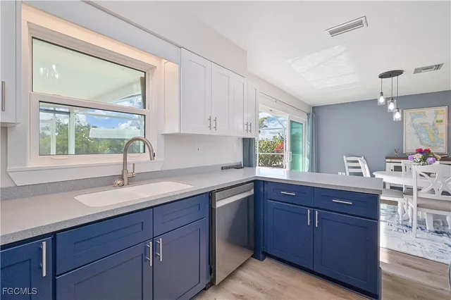 a kitchen with a sink and wooden cabinets
