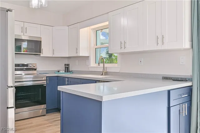a kitchen with stainless steel appliances granite countertop a sink stove and microwave