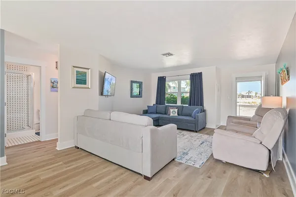 a living room with furniture and wooden floor