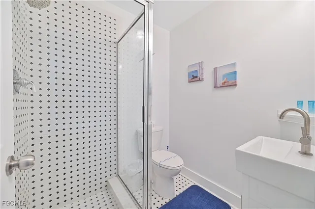 a bathroom with a toilet and a shower curtain