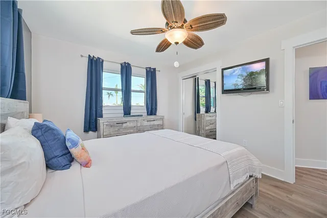 a bedroom with a large bed and a chandelier