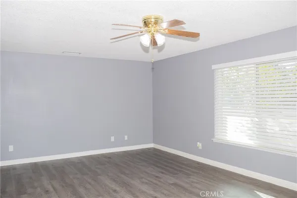 a living room with furniture a large window and chair