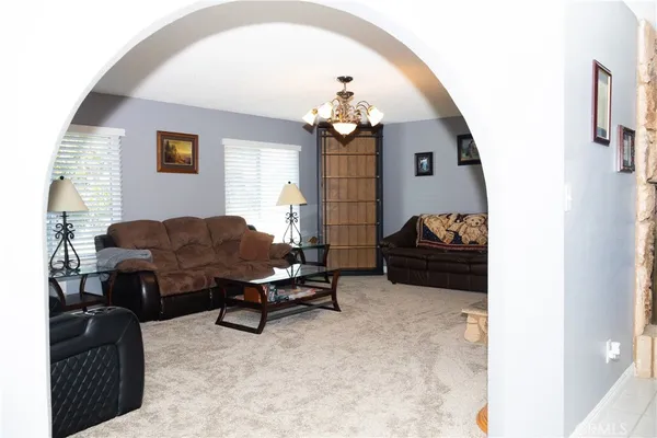 a living room with furniture a clock and a fireplace