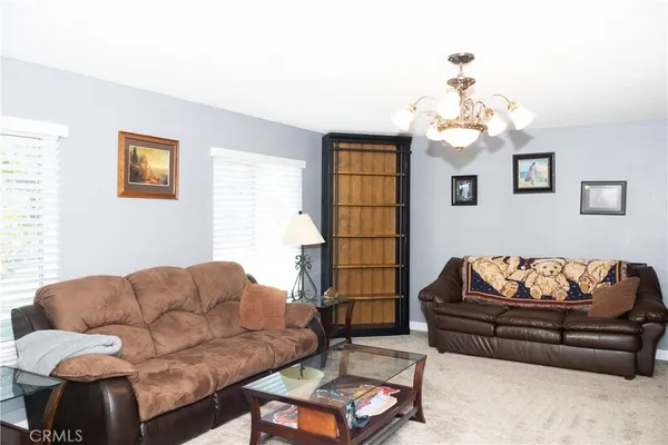 a living room with furniture a flat screen tv and a window