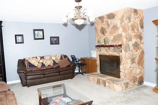 a kitchen with stainless steel appliances kitchen island granite countertop a table chairs and a refrigerator