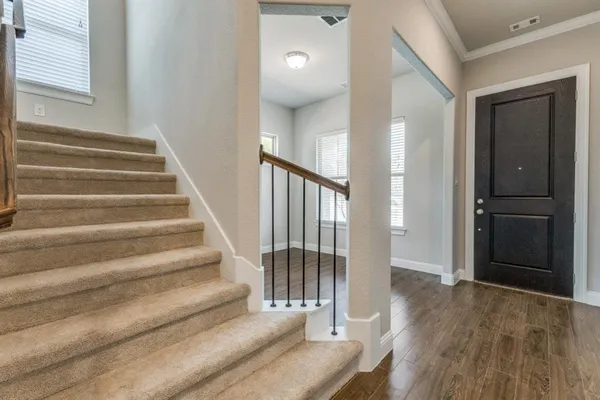 a view of entryway and hall with wooden floor