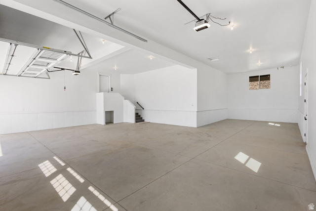 692 East Mountain Road North Ogden, UT 84414 - Photo 16 of 17 Spacious garage featuring a concrete floor, bright white walls with wainscoting, and recessed lighting