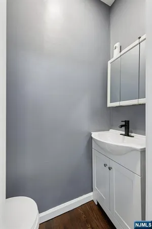 a bathroom with a sink a toilet and mirror