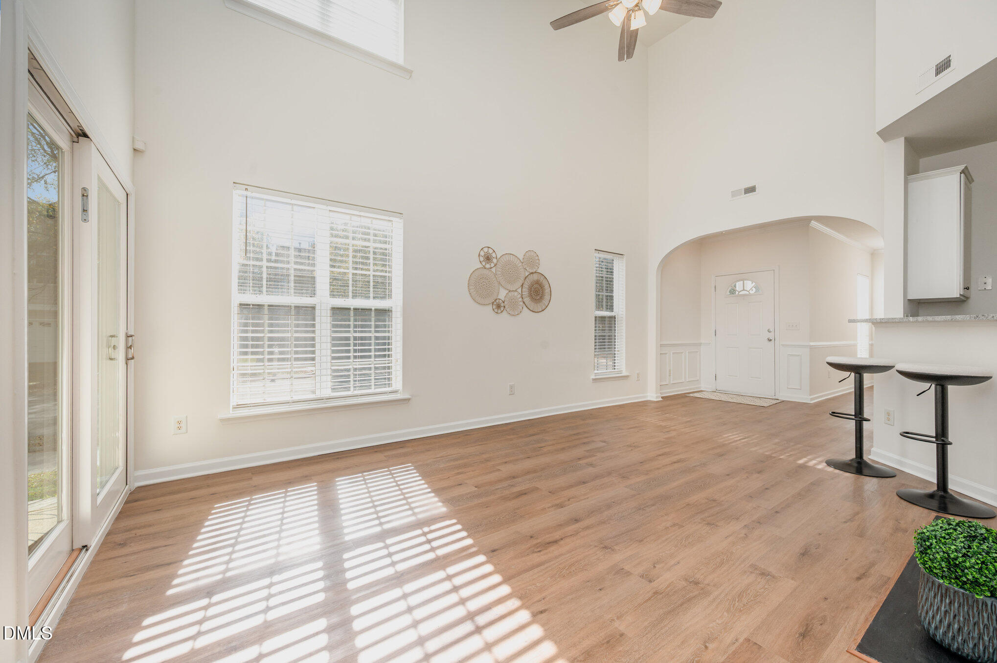 8400 Whisper Ridge Place Raleigh, NC 27613 - Photo 9 of 27 a view of an empty room with window and wooden floor