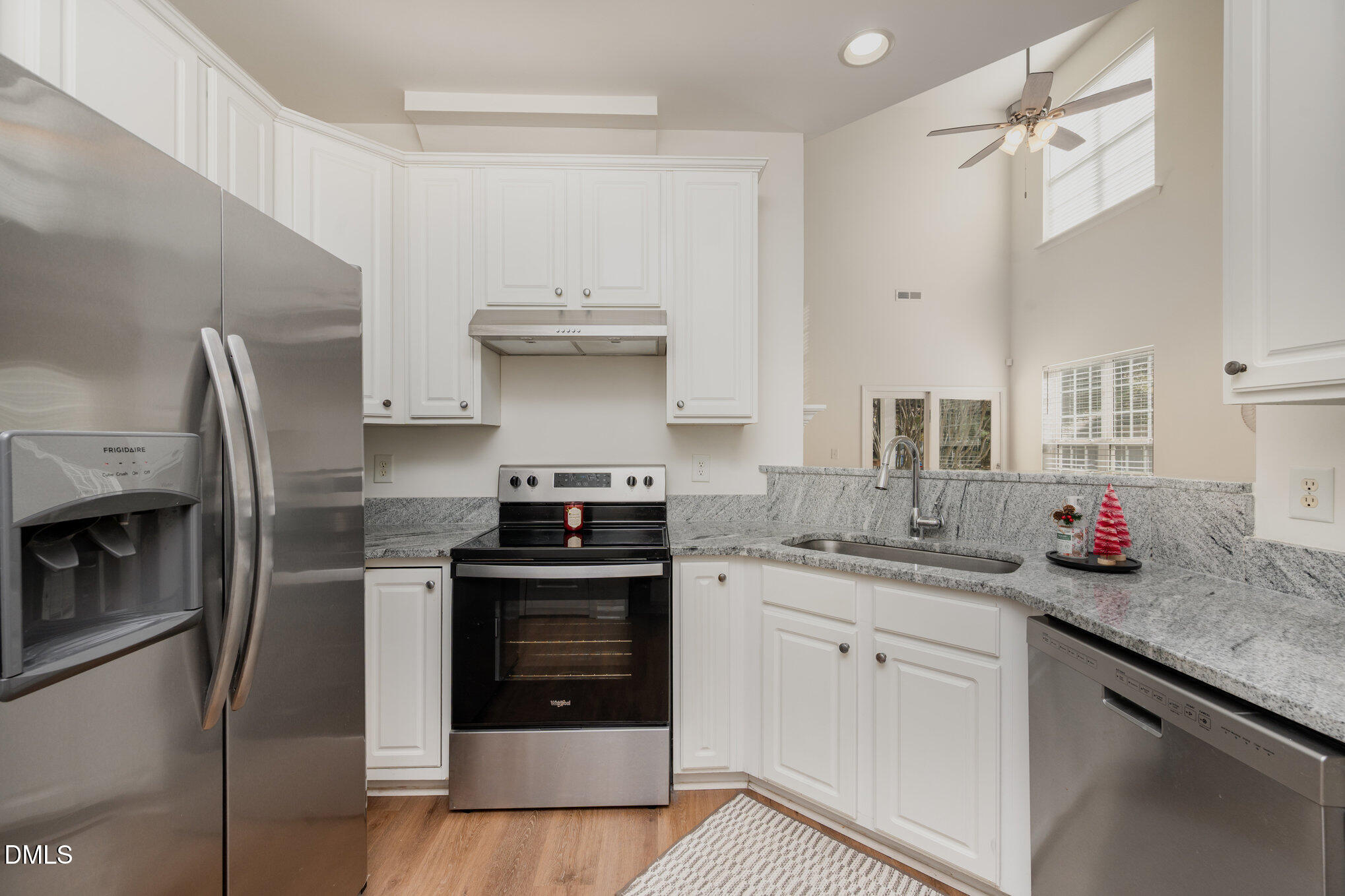 8400 Whisper Ridge Place Raleigh, NC 27613 - Photo 11 of 27 a kitchen with stainless steel appliances granite countertop a sink stove and refrigerator