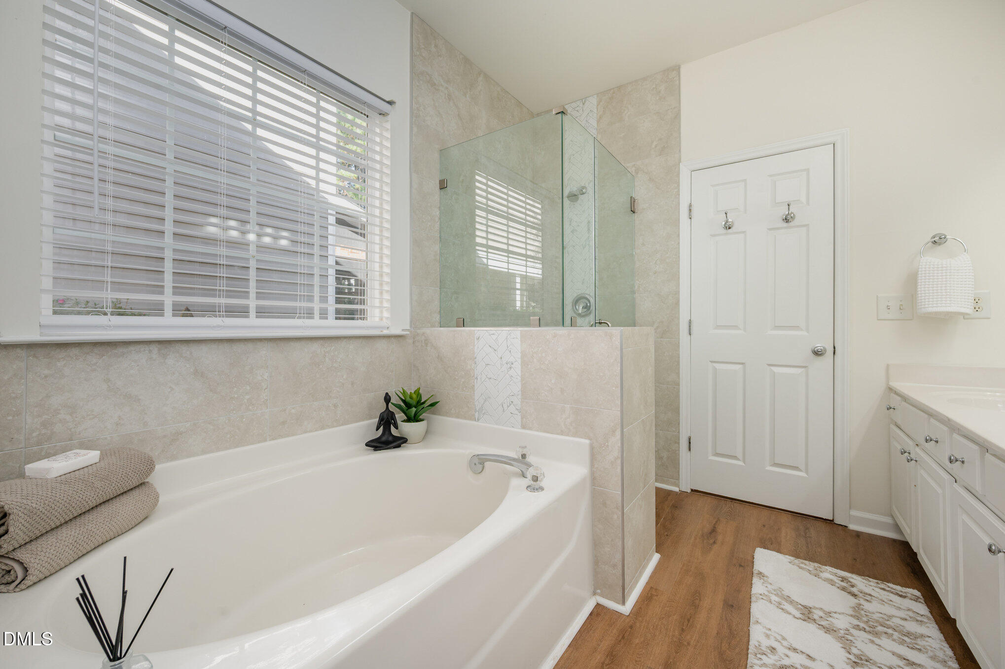 8400 Whisper Ridge Place Raleigh, NC 27613 - Photo 16 of 27 a bathroom with a tub a sink and a window