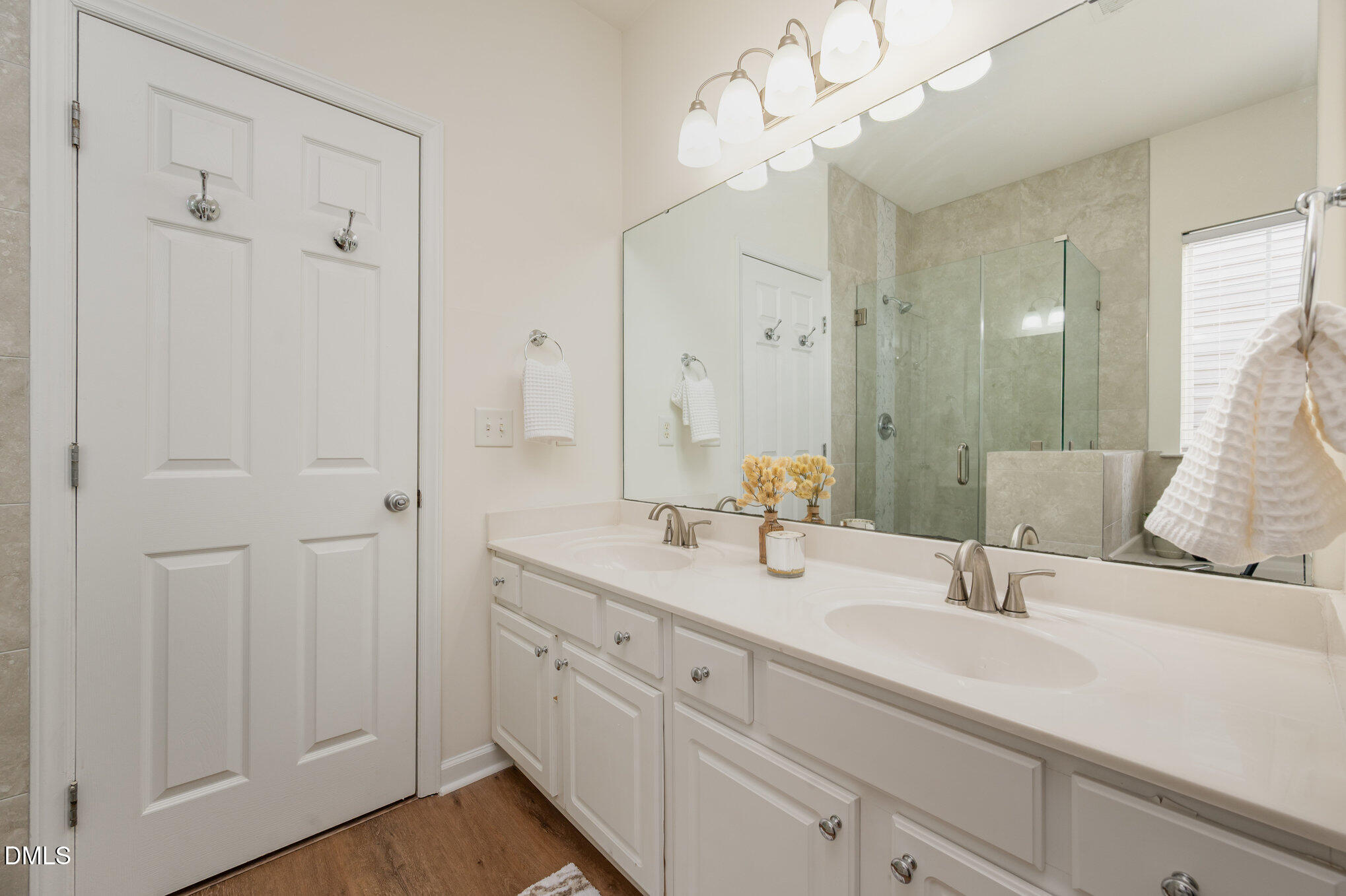 8400 Whisper Ridge Place Raleigh, NC 27613 - Photo 17 of 27 a bathroom with double vanity and a mirror