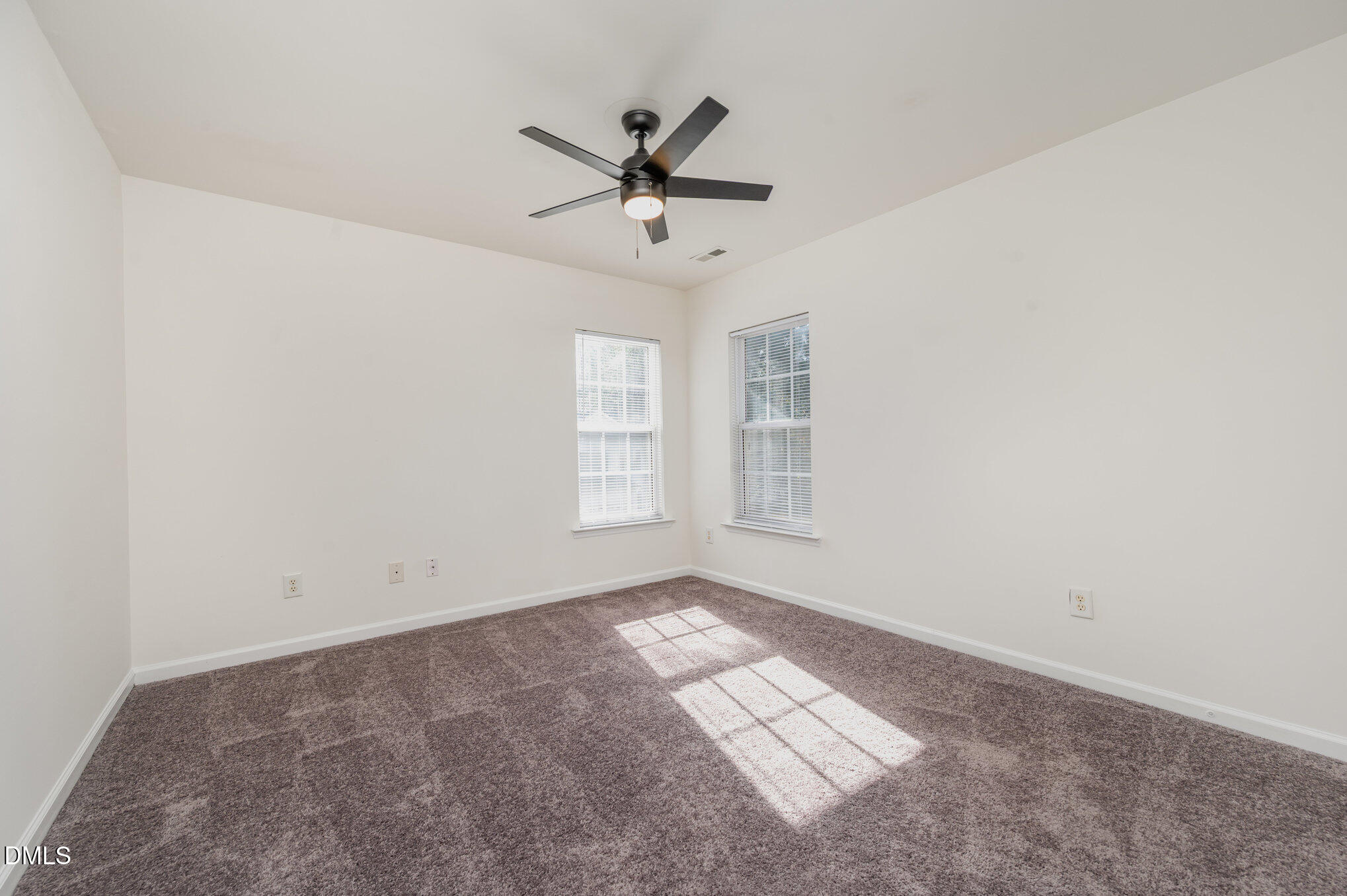 8400 Whisper Ridge Place Raleigh, NC 27613 - Photo 19 of 27 an empty room with windows and fan