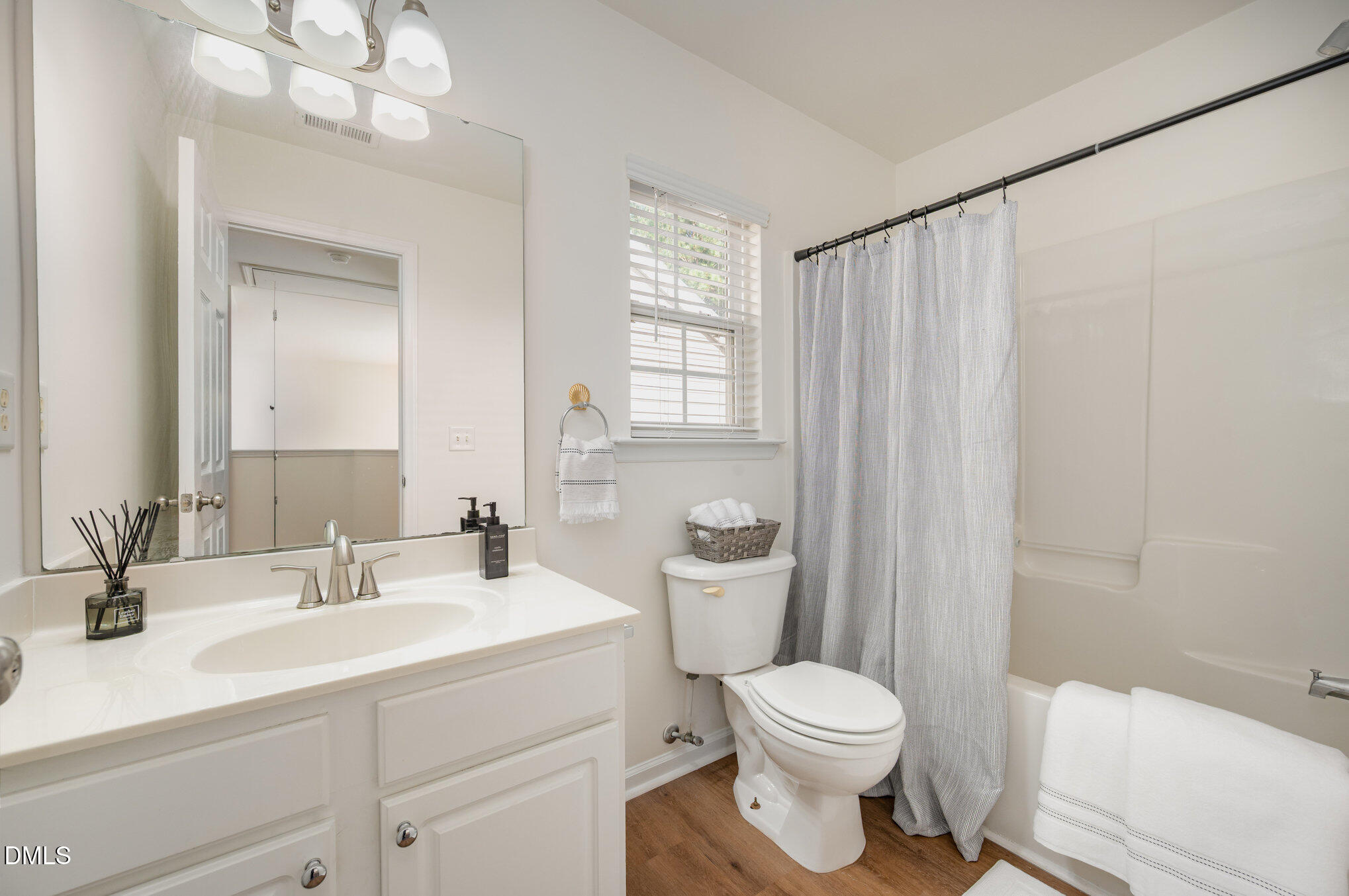 8400 Whisper Ridge Place Raleigh, NC 27613 - Photo 20 of 27 a bathroom with a sink a toilet a mirror a vanity and shower