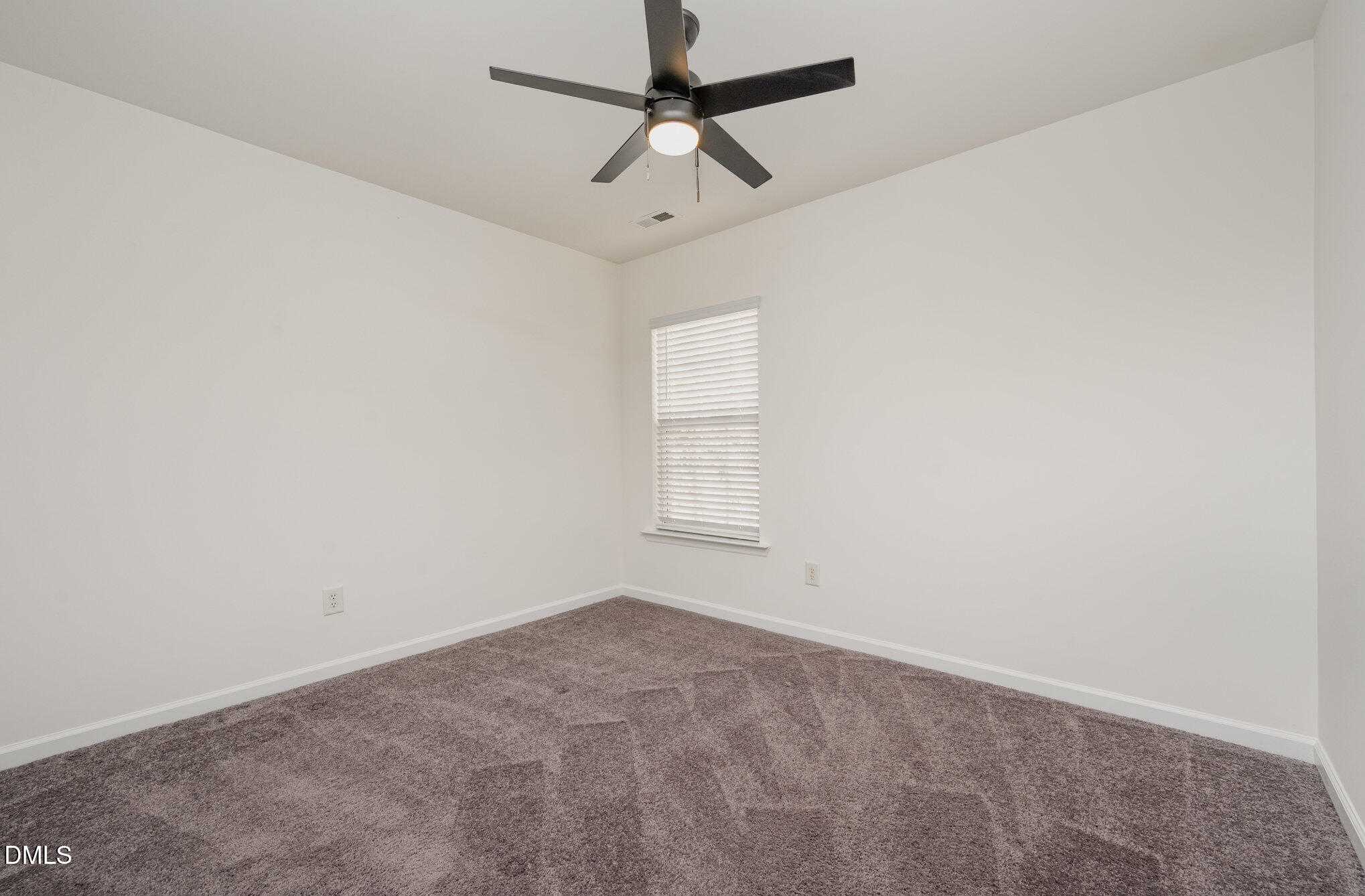 8400 Whisper Ridge Place Raleigh, NC 27613 - Photo 22 of 27 an empty room with a window and a fan