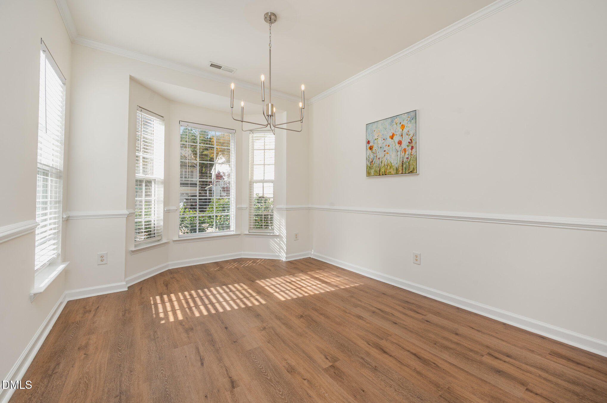 8400 Whisper Ridge Place Raleigh, NC 27613 - Photo 6 of 27 a view of an empty room with wooden floor and a window