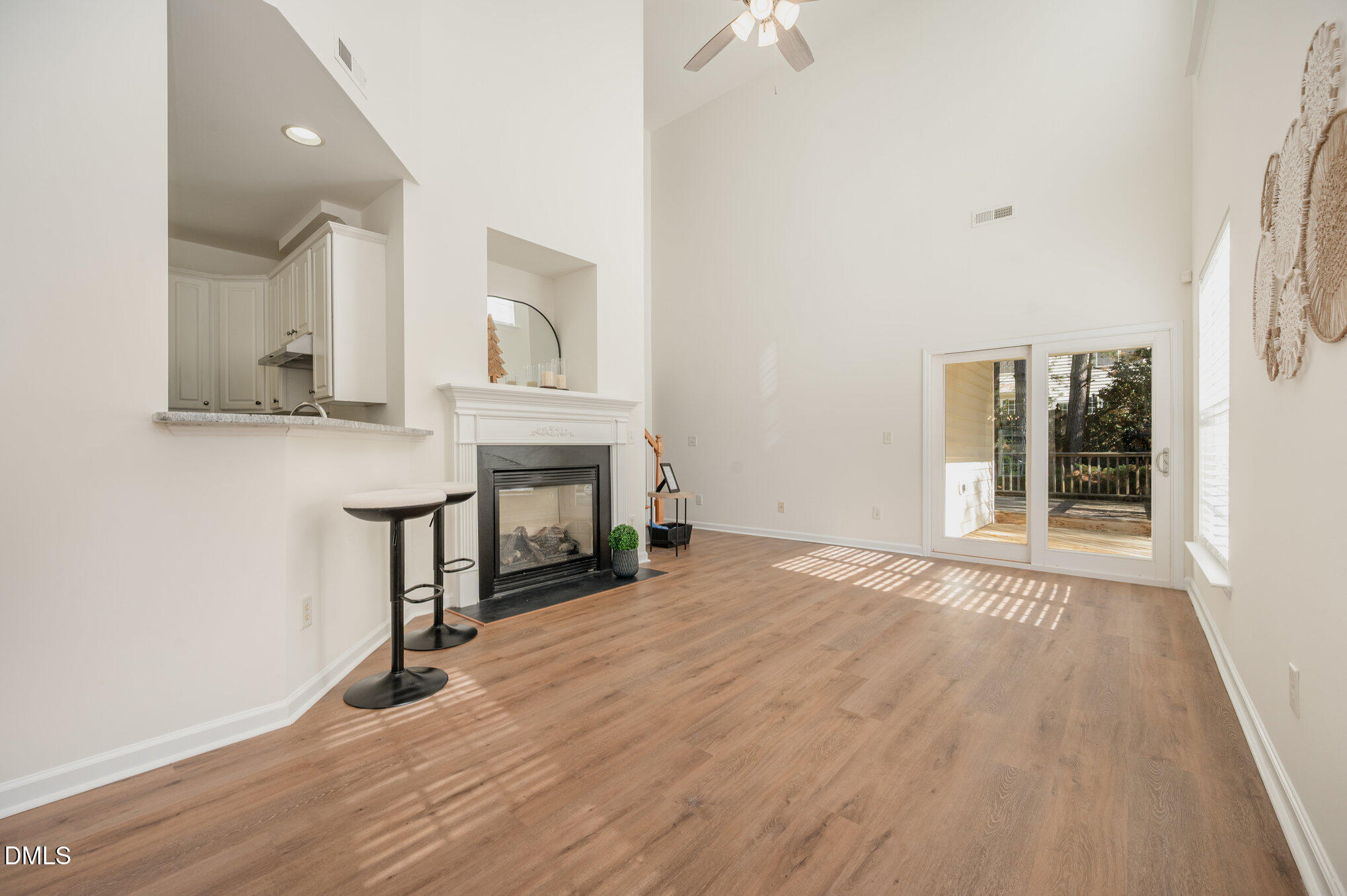 8400 Whisper Ridge Place Raleigh, NC 27613 - Photo 7 of 27 a view of empty room with wooden floor and fireplace