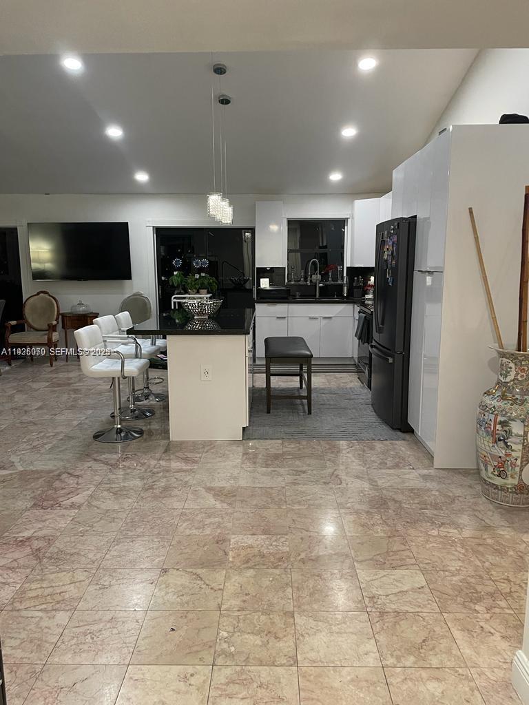 13424 Southwest 90th Terrace Miami, FL 33186 - Photo 8 of 14 a living room with stainless steel appliances furniture a rug and a view