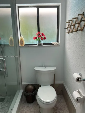 a white toilet sitting next to a bathroom sink