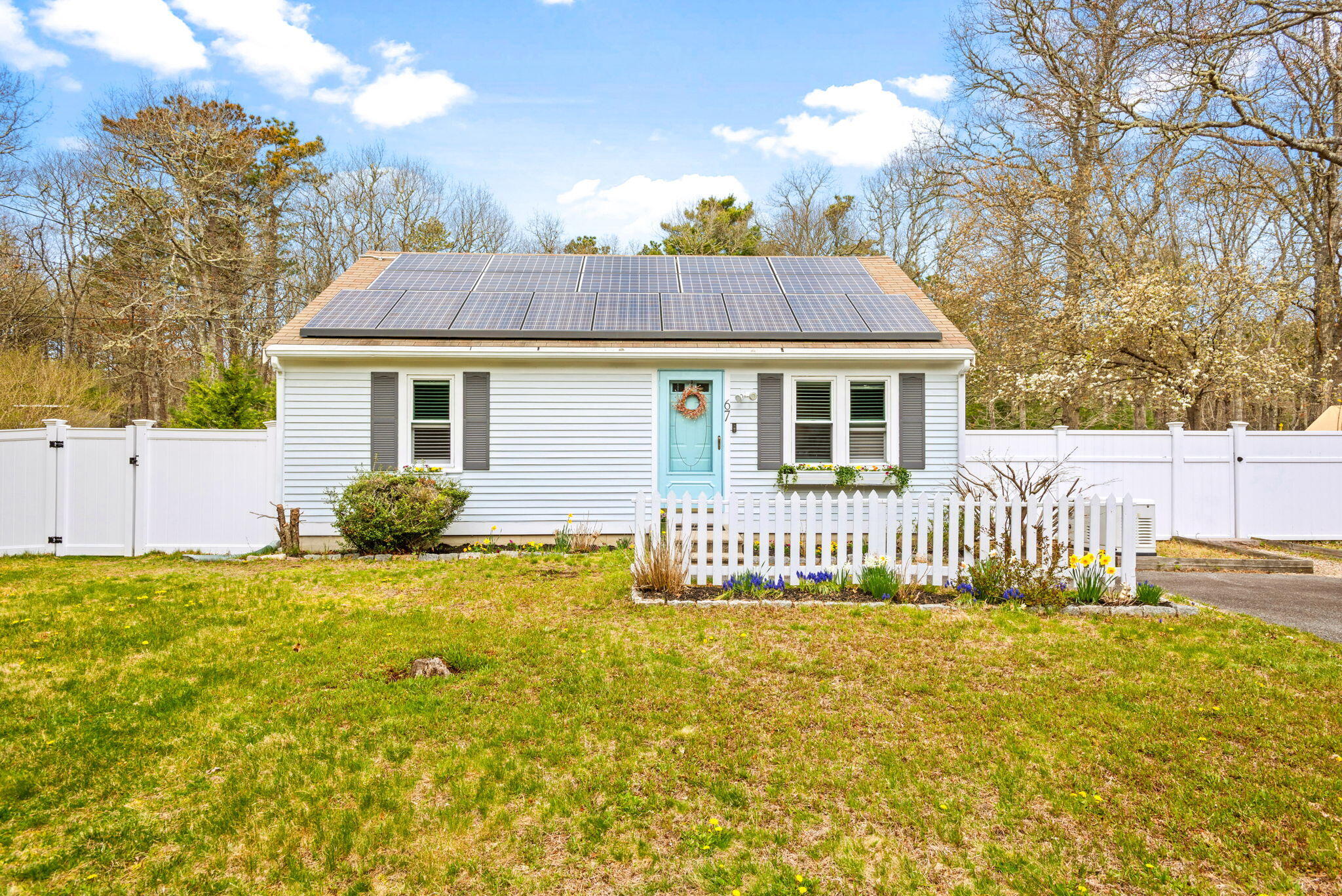 67 Degrass Road Mashpee, MA 02649 - Photo 1 of 24 a front view of a house with a garden