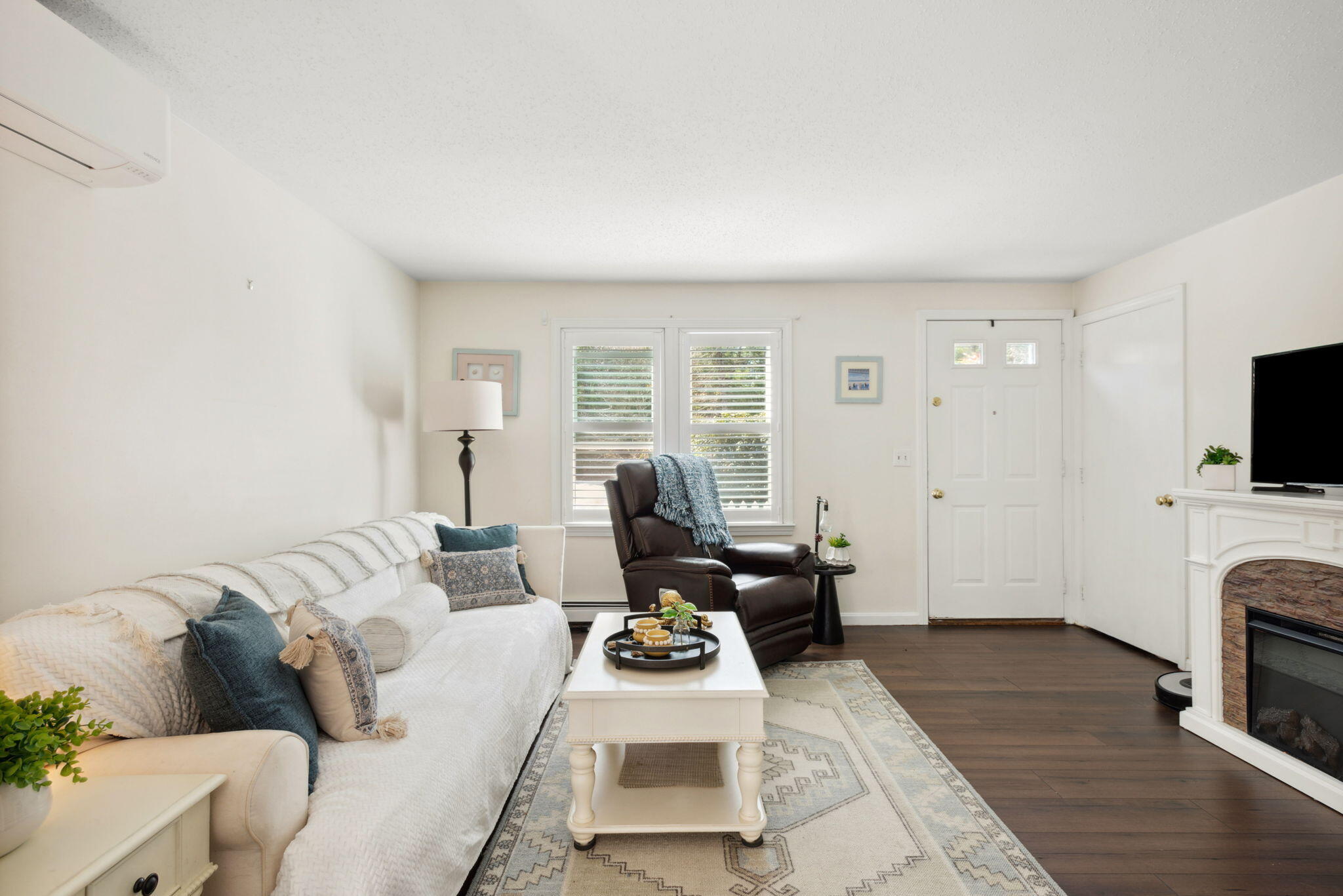 67 Degrass Road Mashpee, MA 02649 - Photo 5 of 24 a living room with furniture a flat screen tv and a fireplace