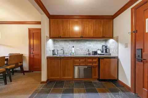 a kitchen with granite countertop cabinets and refrigerator