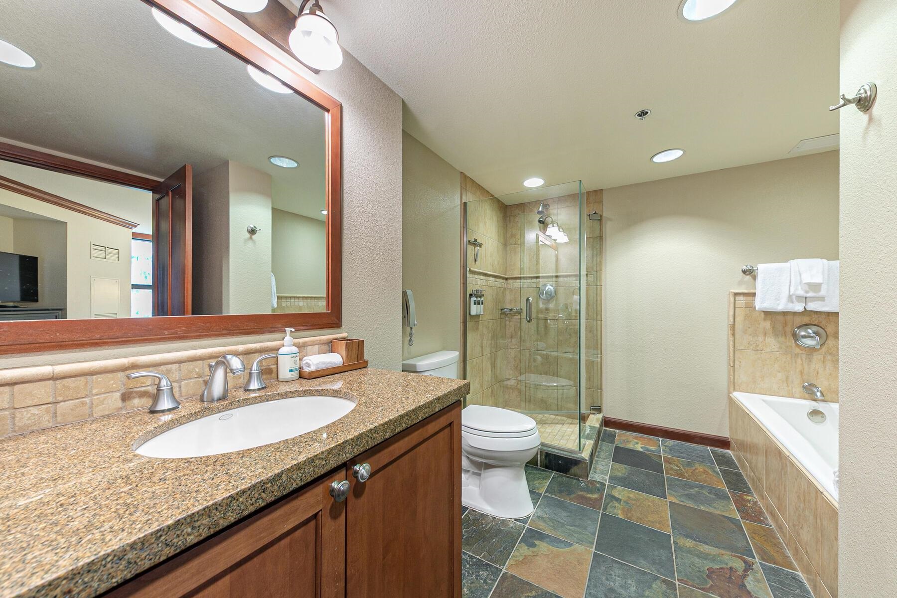 400 Resort Road, Unit 722724 Olympic Valley, CA 96146 - Photo 24 of 28 a bathroom with a granite countertop sink a toilet a mirror and shower