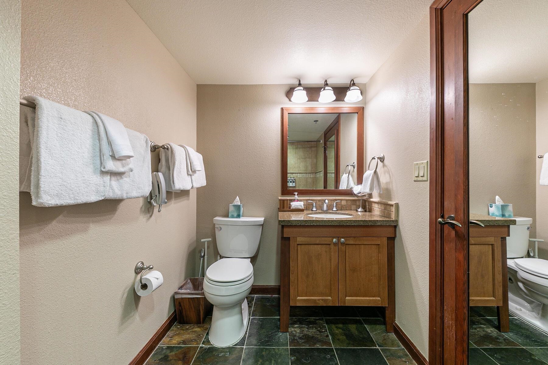 400 Resort Road, Unit 722724 Olympic Valley, CA 96146 - Photo 27 of 28 a bathroom with a granite countertop toilet sink and mirror