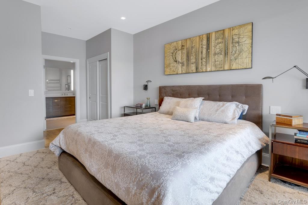 18 Rivers Edge Drive, Unit 211 Tarrytown, NY 10591 - Photo 17 of 30 a bedroom with bed and wall painting