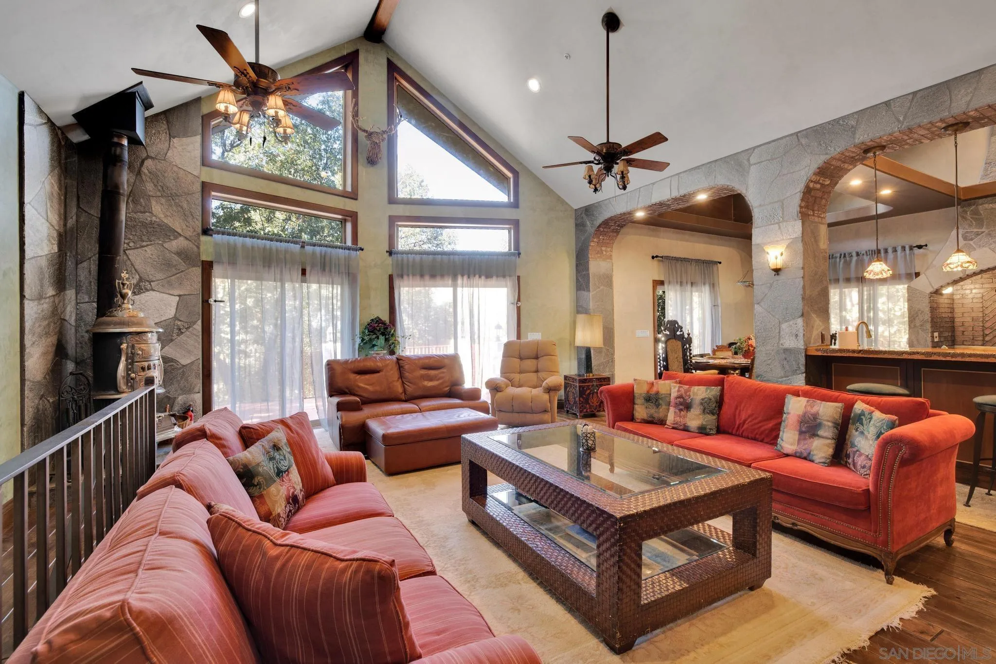 3217 Pera Alta Drive Julian, CA 92036 - Photo 13 of 37 a living room with furniture a ceiling fan and a large window