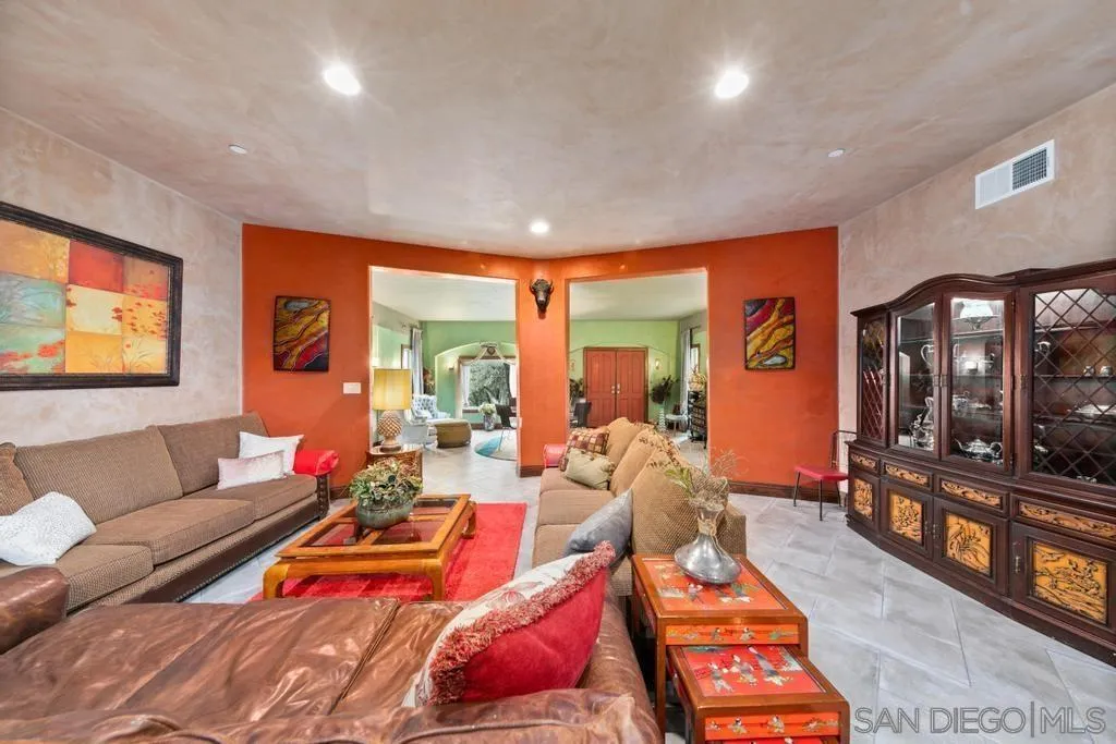 3217 Pera Alta Drive Julian, CA 92036 - Photo 10 of 37 a living room with furniture a flat screen tv and a floor to ceiling window