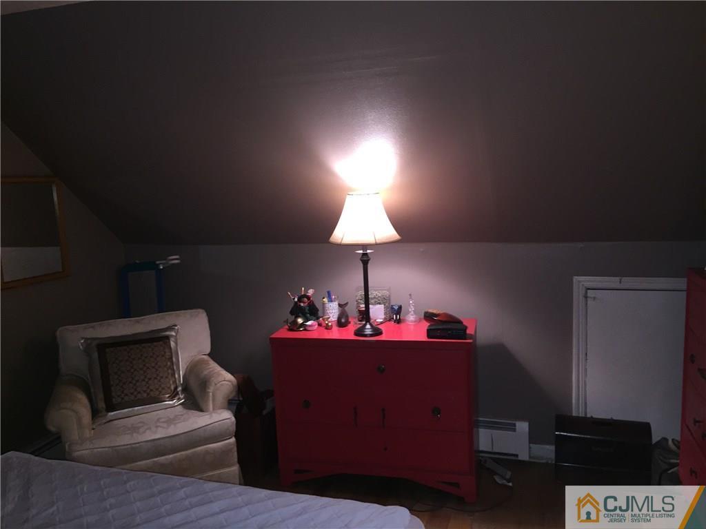 168 East Hill Road Colonia, NJ 07067 - Photo 22 of 24 a living room with furniture and a fireplace