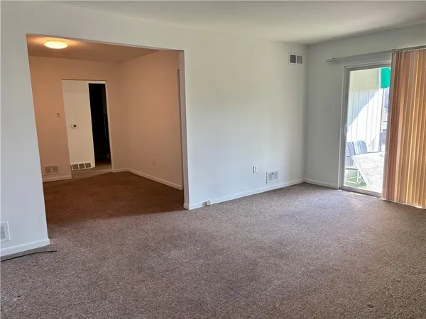 an empty room with windows and closet