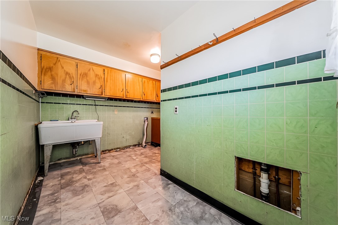 550 Cooper Foster Park Road Lorain, OH 44053 - Photo 24 of 50 Laundry room with tile walls and a sink