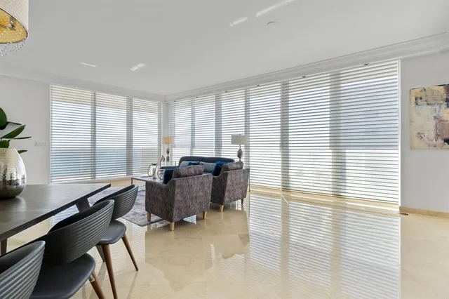 a bedroom with a white bed and white furniture