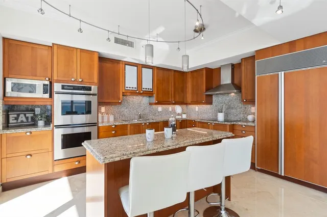 a bathroom with a granite countertop sink a toilet and a mirror