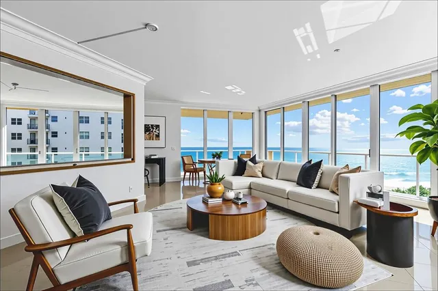 a spacious bedroom with a bed chandelier and a large window