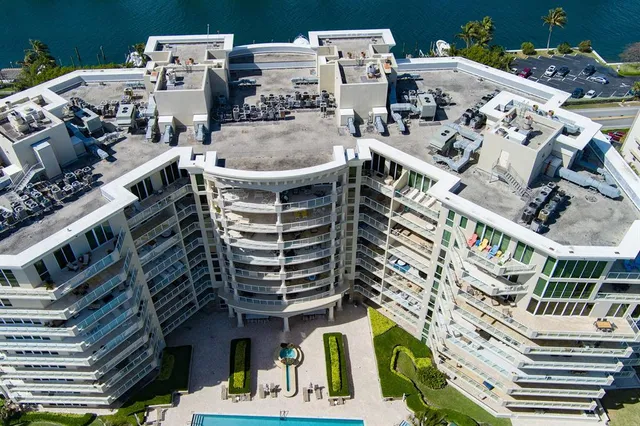 a view of a building with plants and outdoor seating