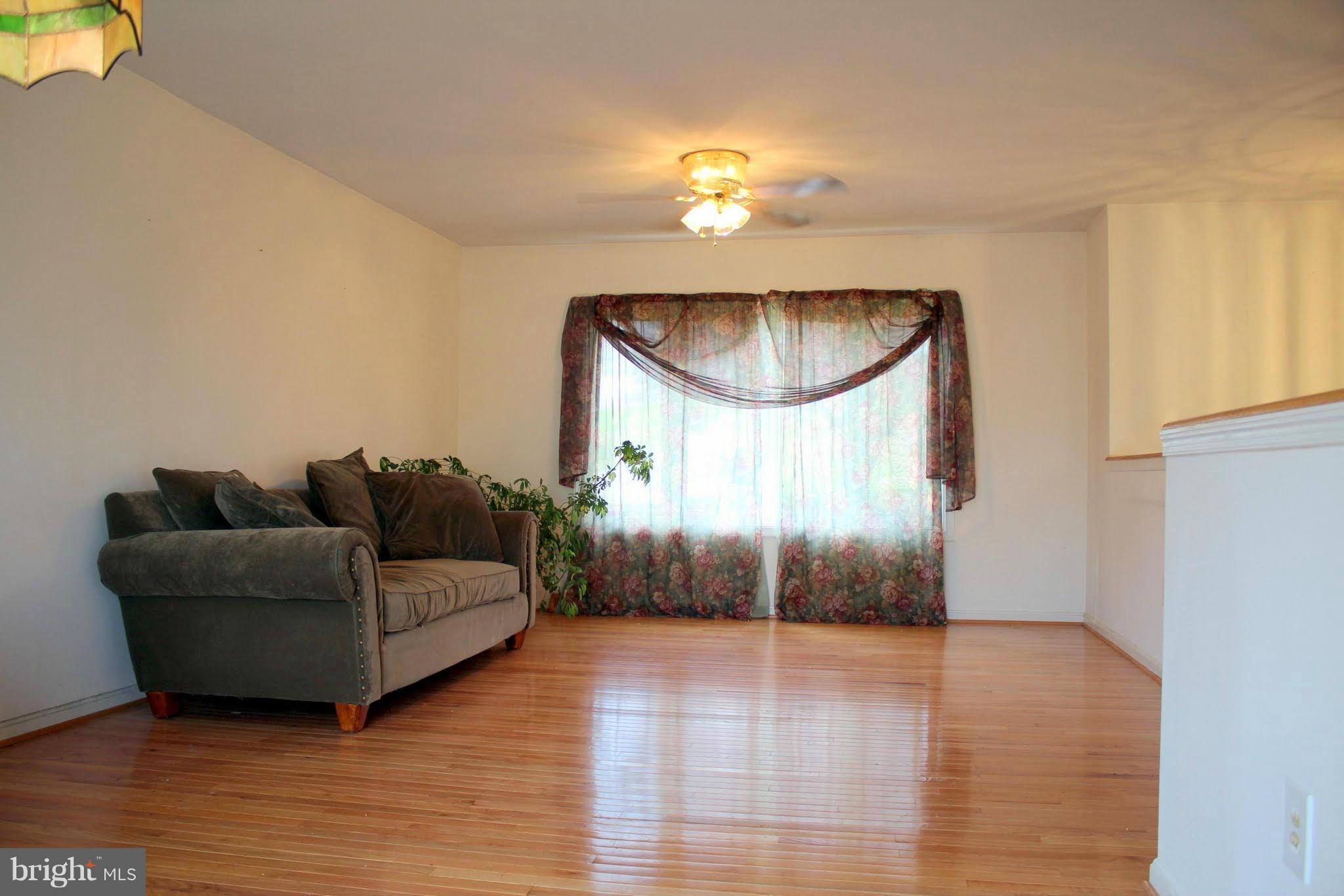 2416 Raintree Avenue Westminster, MD 21157 - Photo 11 of 27 a living room with furniture and a wooden floor