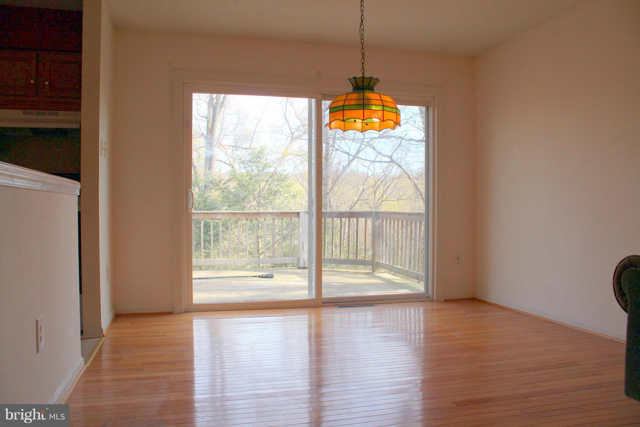 2416 Raintree Avenue Westminster, MD 21157 - Photo 13 of 27 a view of an empty room with wooden floor and a window