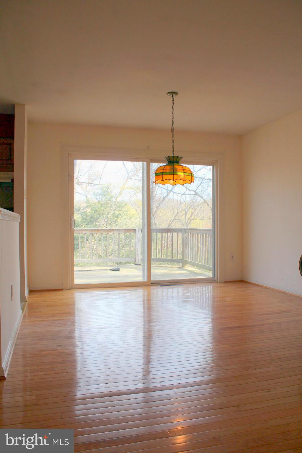 2416 Raintree Avenue Westminster, MD 21157 - Photo 14 of 27 a view of an empty room with wooden floor and a window